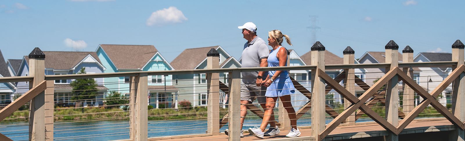 Couple walking on bridge in Riverlights community located in Wilmington, NC