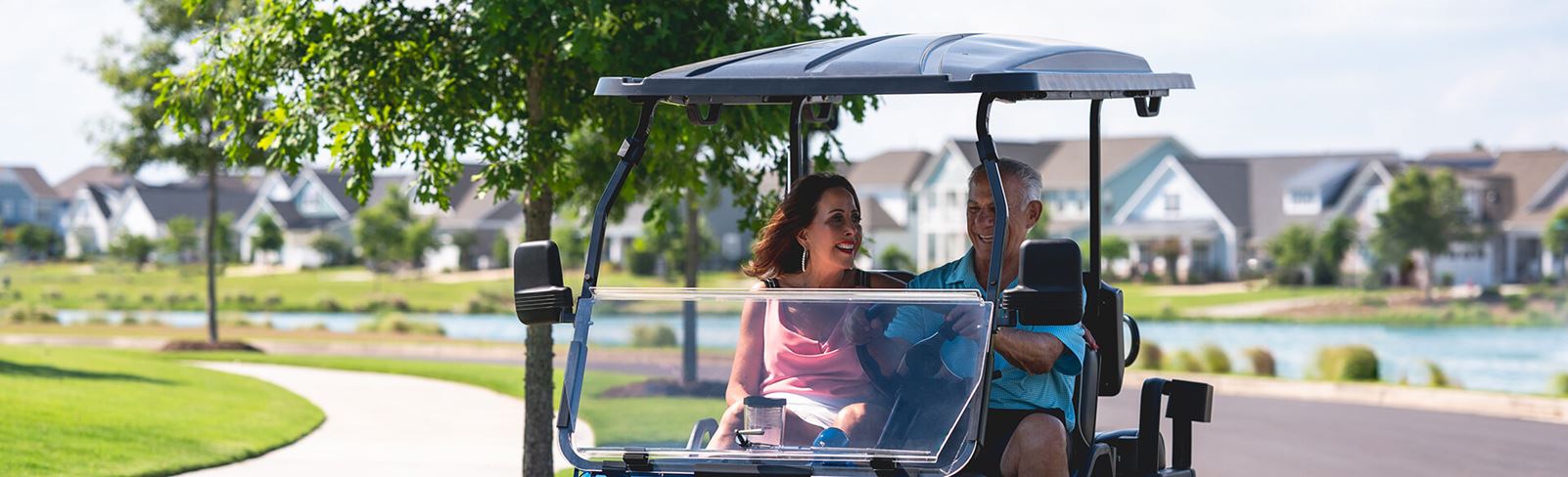 Couple in golf cart in Riverlights community located in Wilmington, NC